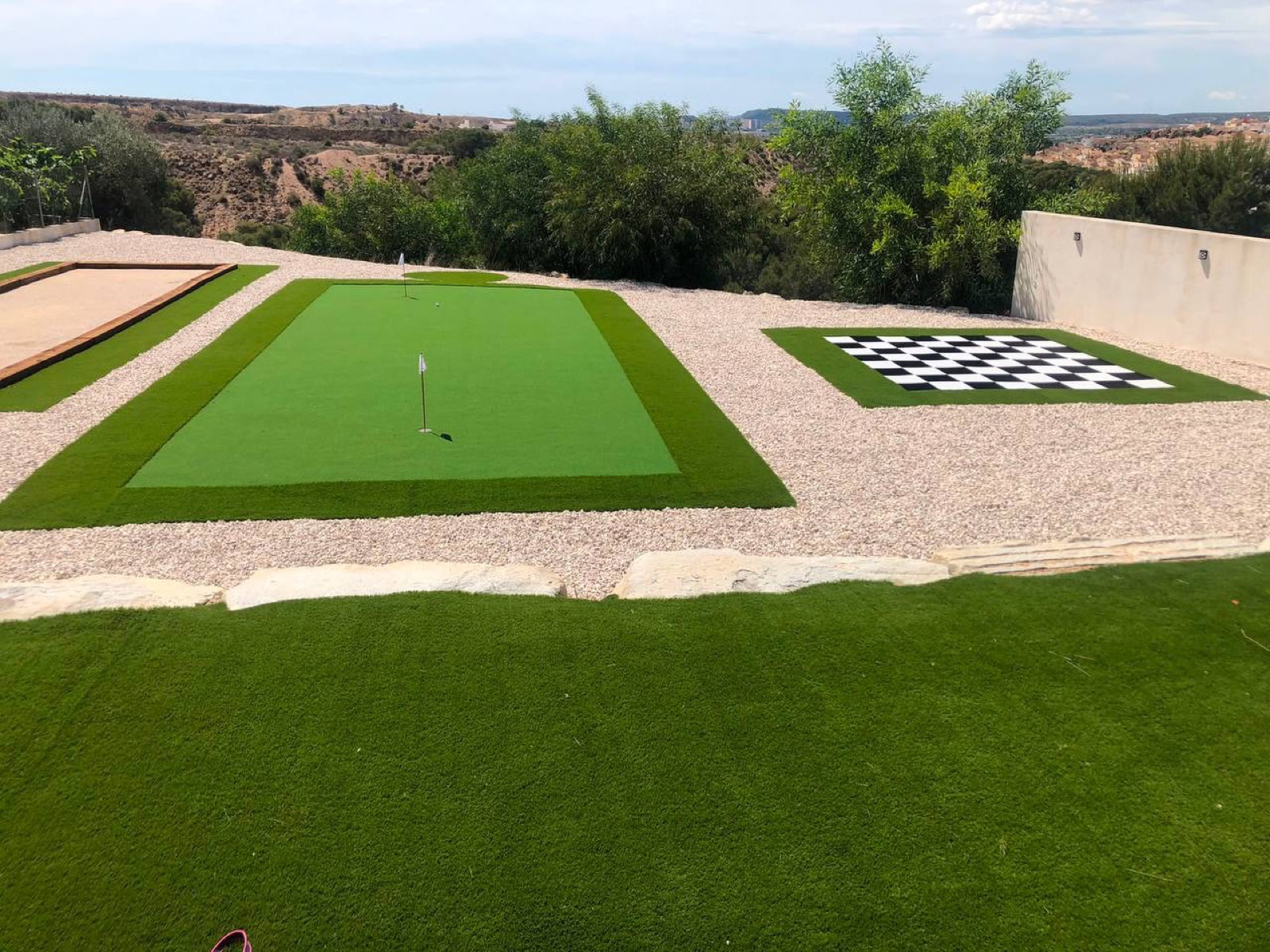 Putting green and games area with artificial grass
